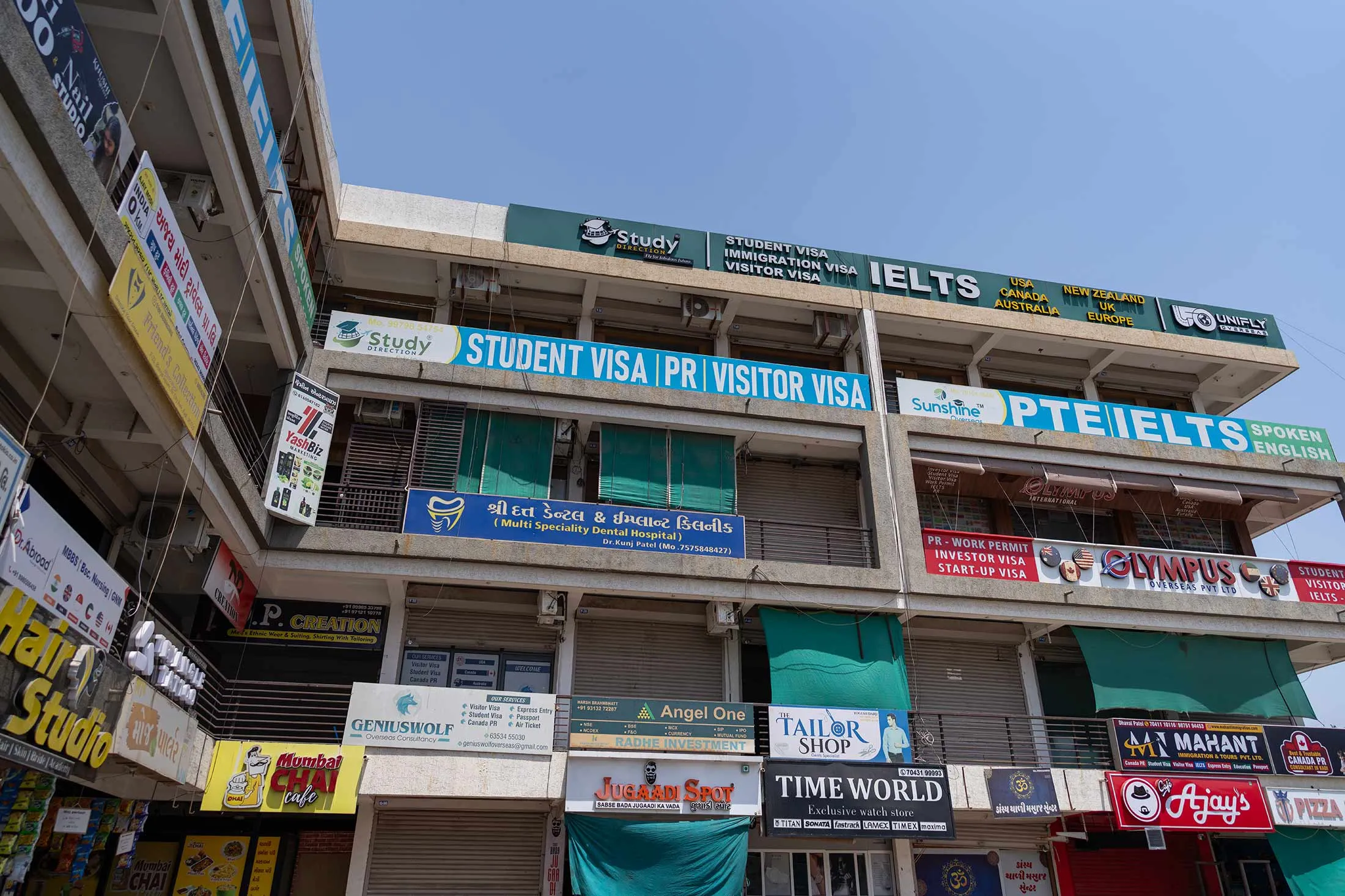 A community center with shops offering passport and visa services in the state of Gujarat, India.