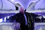 Richard Branson stands inside an Airbus A320 Virgin America airplane.