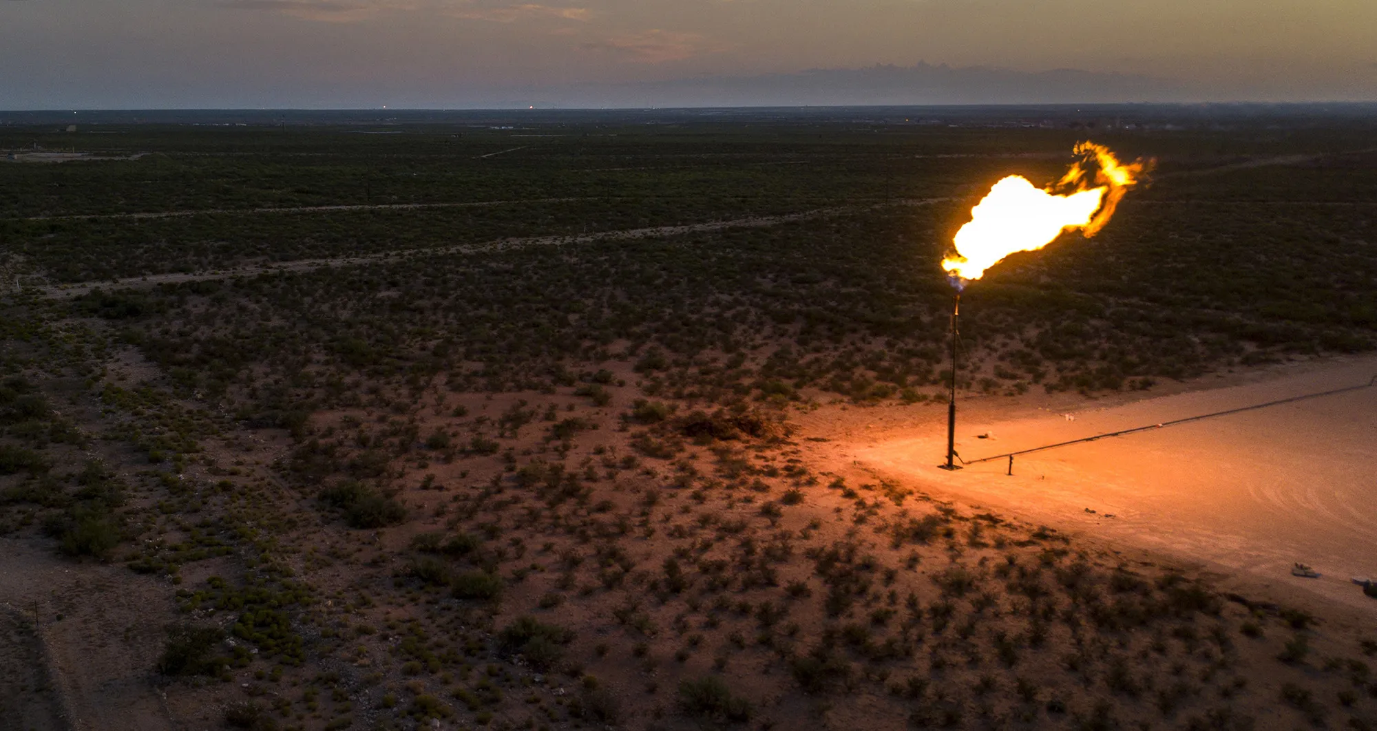 A gas flare is seen at dusk in this aerial photograph taken above a field near Mentone, Texas.