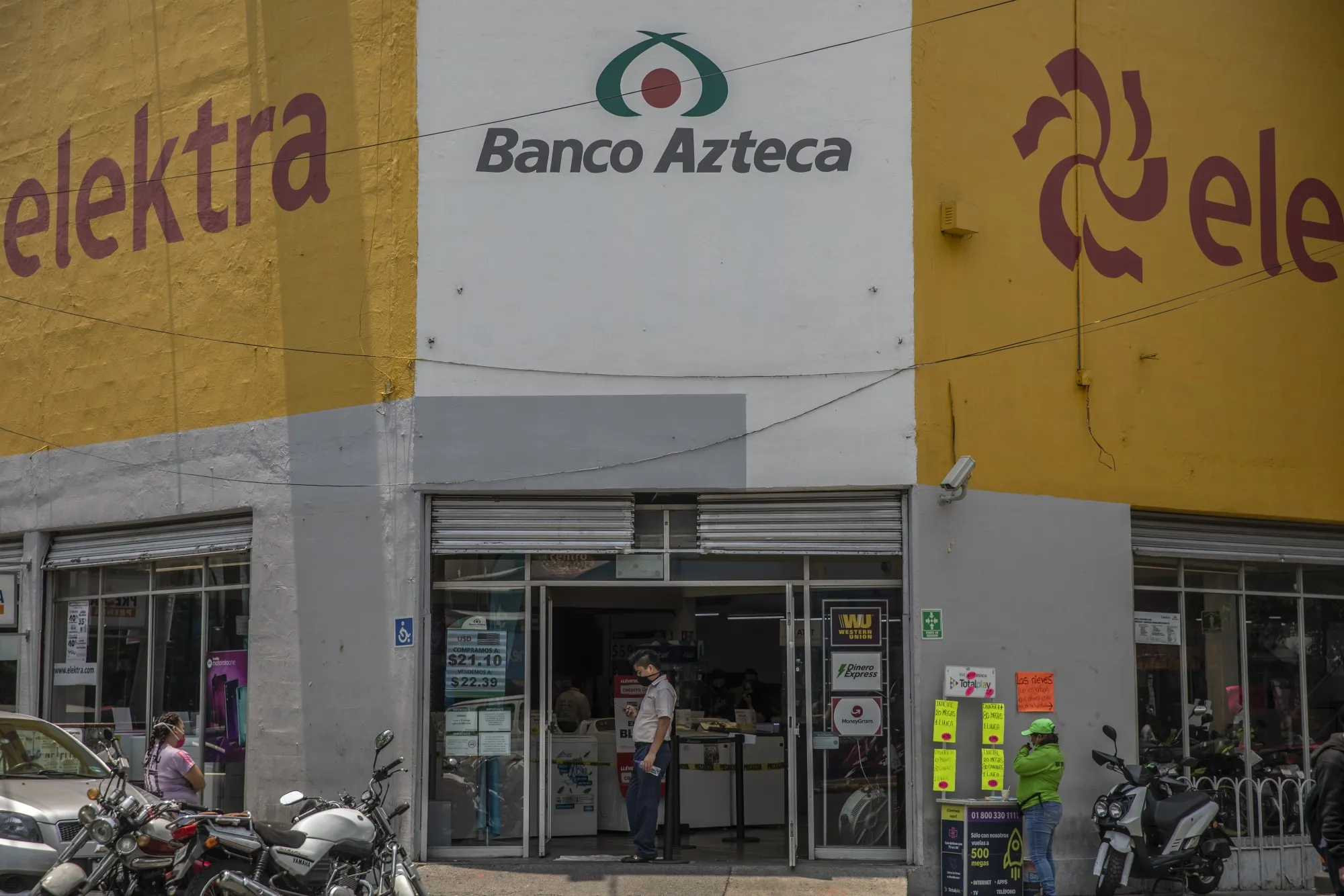 An employee stands at the entrance to a Banco Azteca SA bank branch inside a Grupo Elektra SAB store in Mexico City, Mexico, on May 27, 2020.