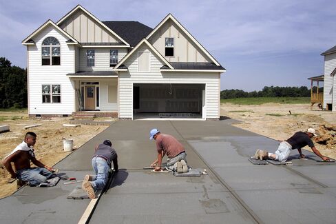 Carpenters install vinyl siding on a Centex