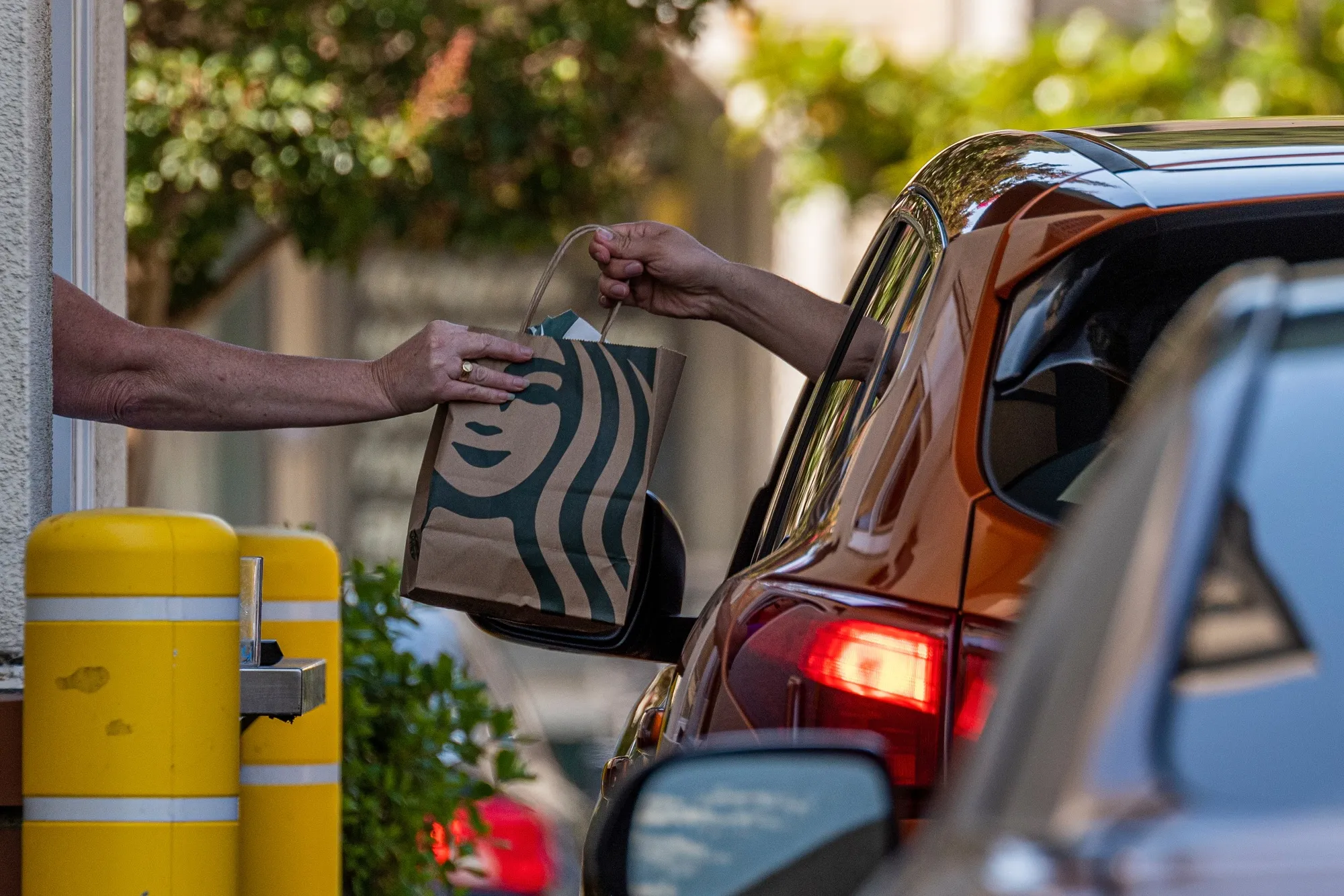 Starbucks plans to accelerate store renovations while opening more locations that target on-the-go customers with formats such as double-sided drive-thrus.