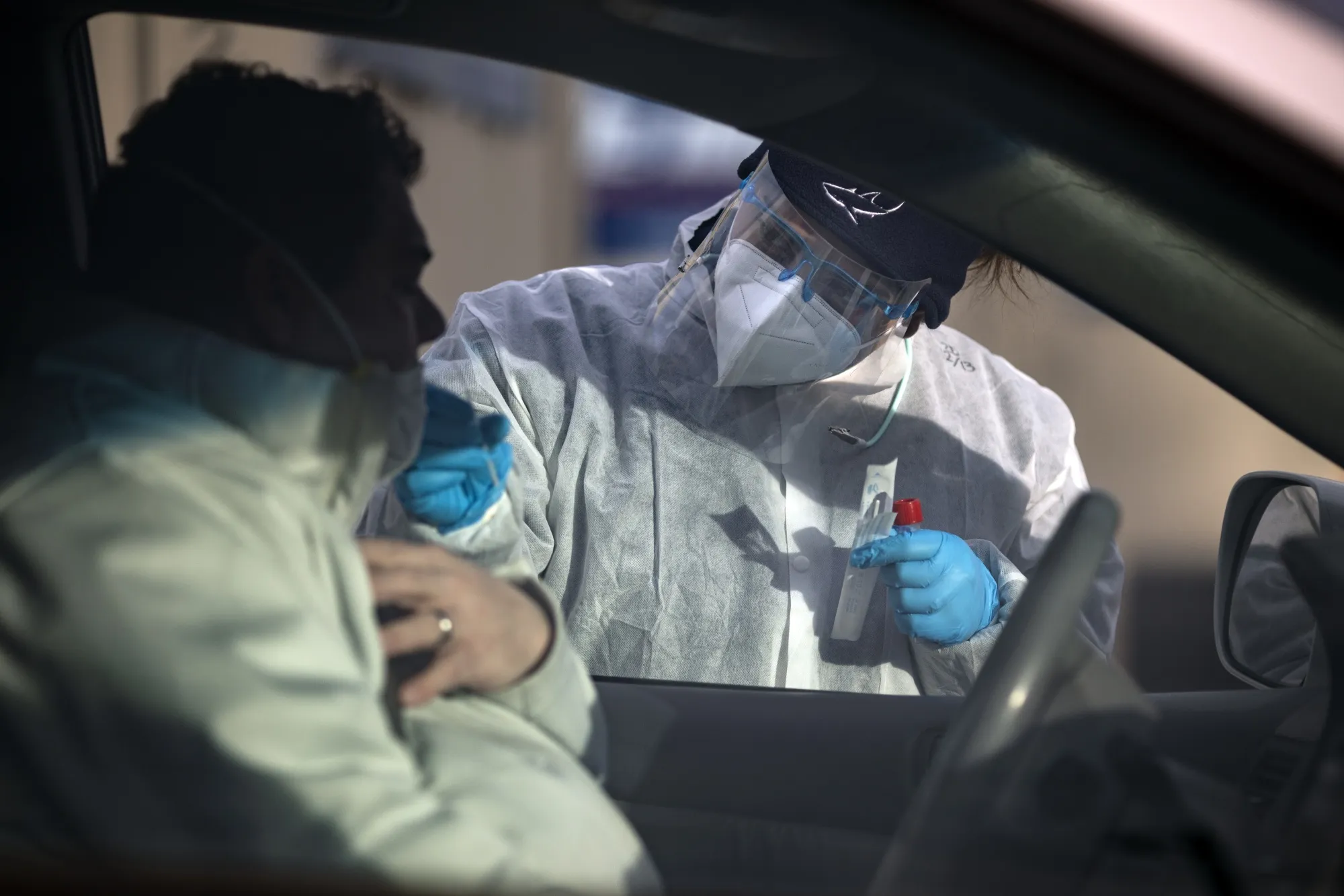 A healthcare worker administers a Covid-19 swab test in Longmont, Colorado.