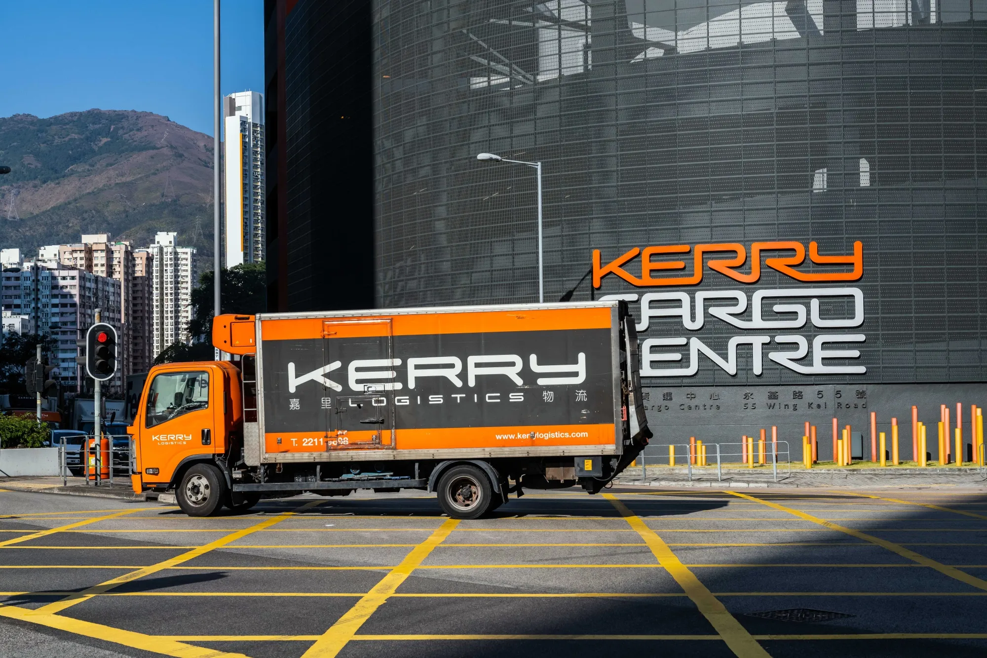 A Kerry Logistics Network Ltd. truck travels past the Kerry Cargo Center in Hong Kong, China.