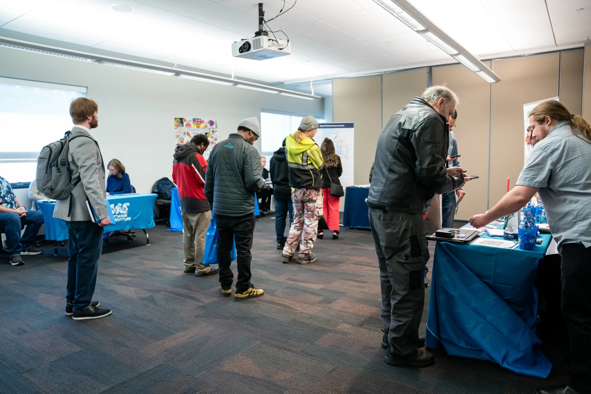 Jobseekers wait to speak to recruiters during the WorkSource North Seattle Career Fair in Seattle on Feb. 10.