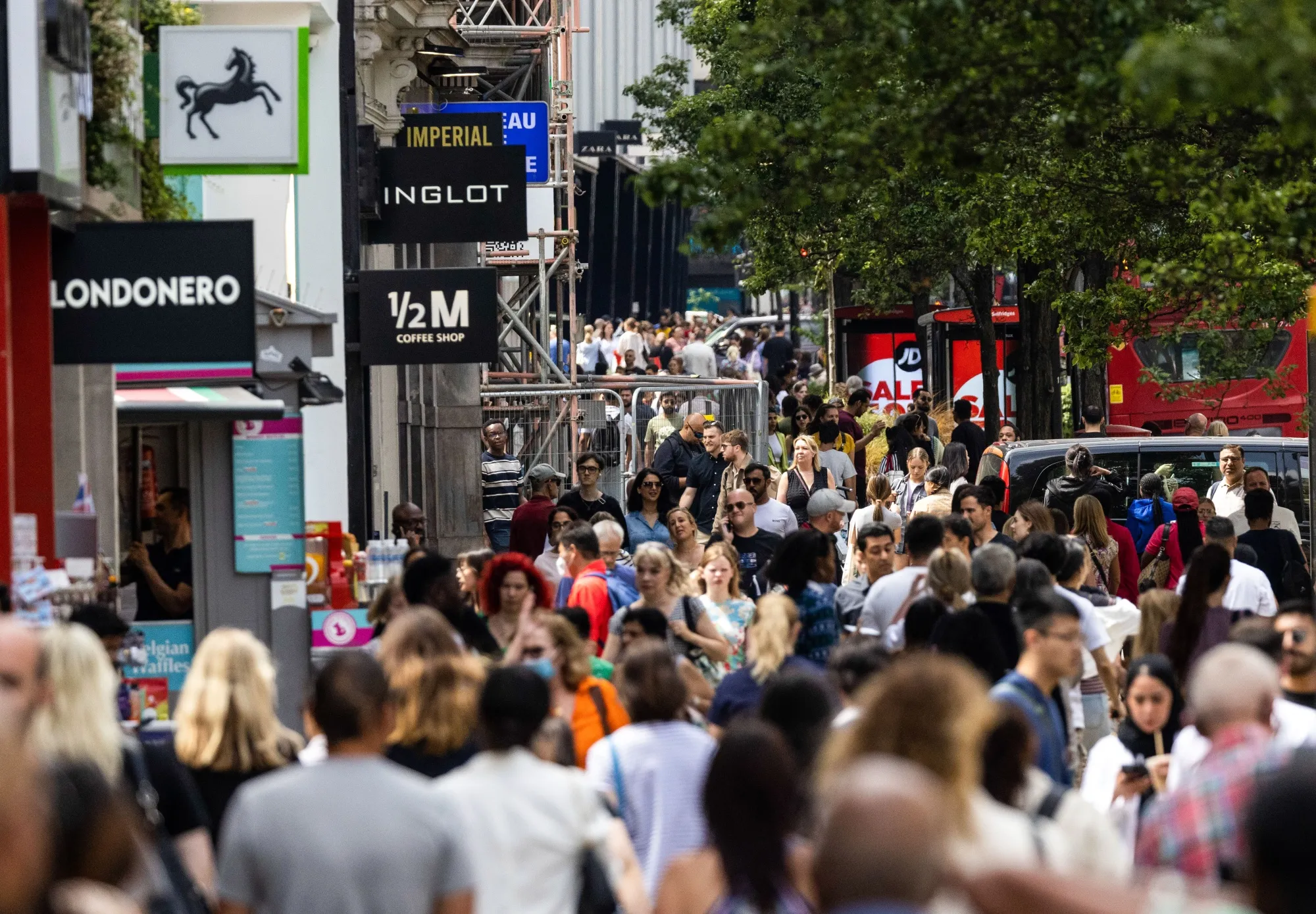 Shoppers walk along Oxford Street in London.