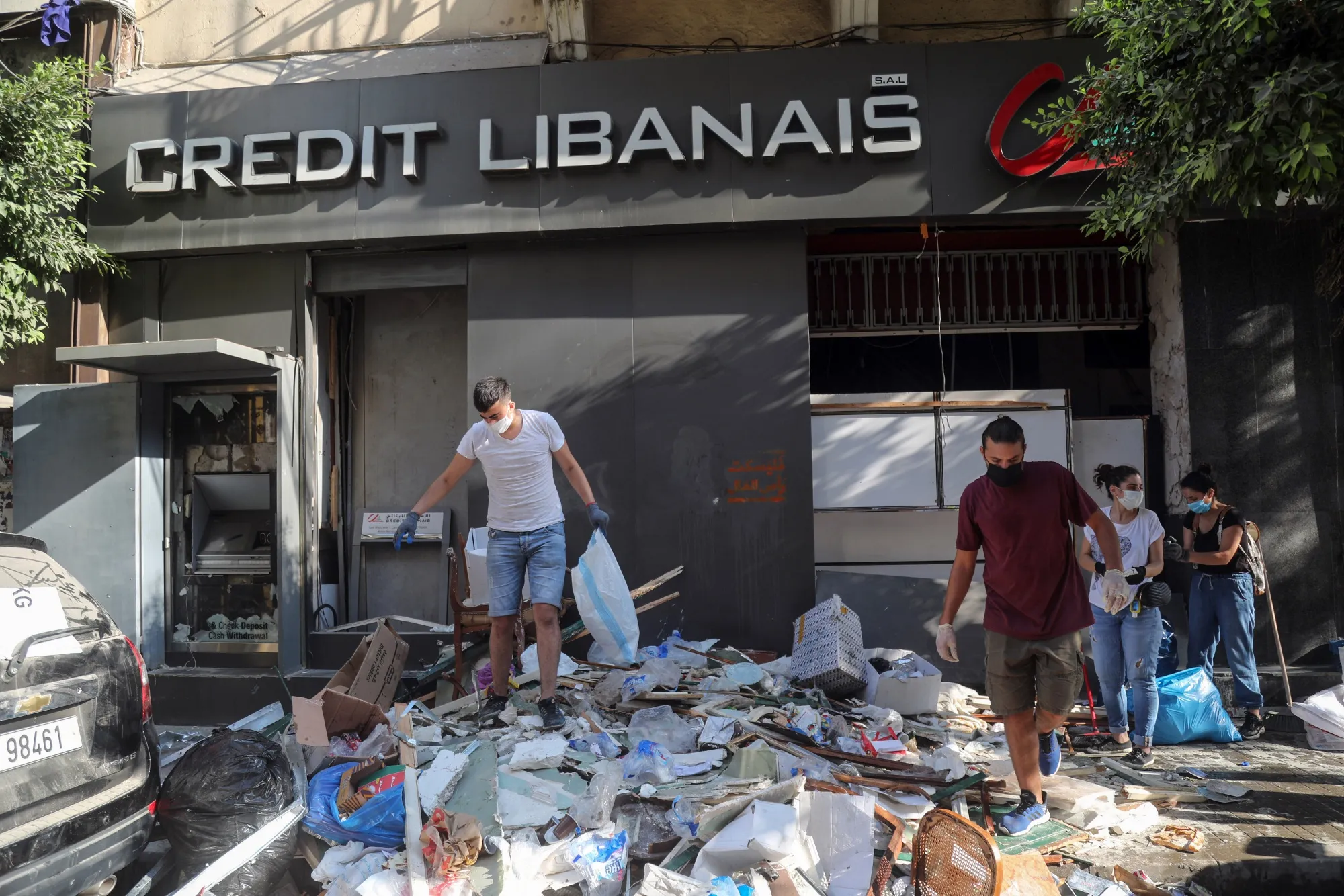 Volunteers remove debris from a destroyed bank near the Port of Beirut in Beirut, Lebanon, Aug. 7.