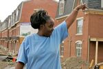 Viola Sowell, 34, shows visitors the new Hope VI neighborhood in the hill district of Pittsburgh that she hopes to move into by August 2008 on May 7, 2008. New regulations that require residents have a job could keep Sowell and her family out of the new neighborhood. 