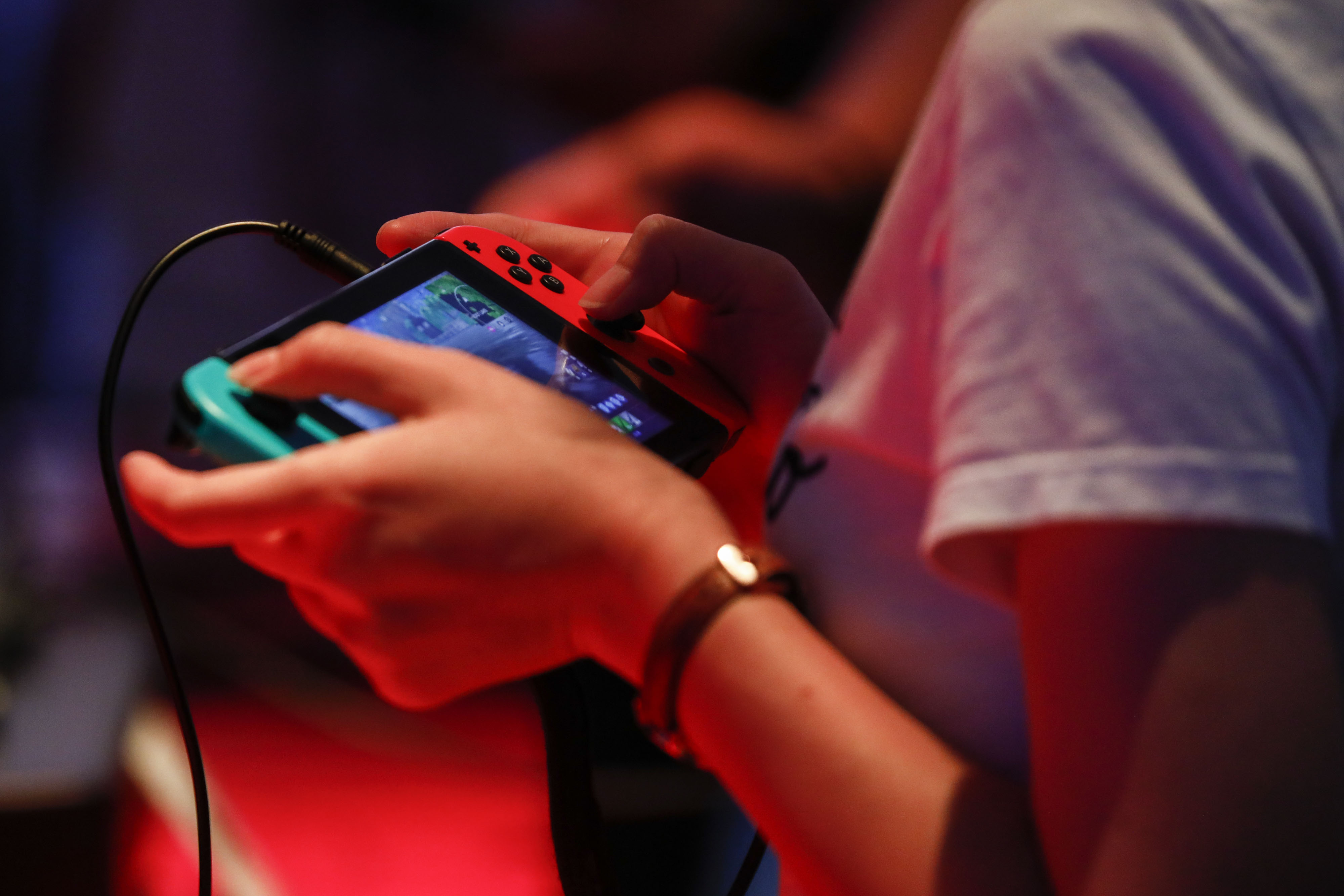 An attendee plays a video game on a Nintendo Switch console.