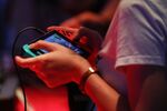 An attendee plays a video game on a Nintendo Switch console.