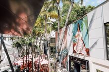 Bony Ramirez's public mural 'Musa Coccinea,' that depicts a woman draped in a lush Victorian gown adorned with red flowers.