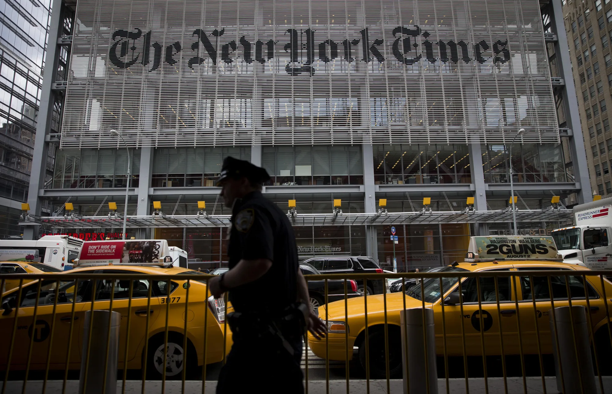 An NYPD police officer passes in front of the offices of The New York Times in New York.
