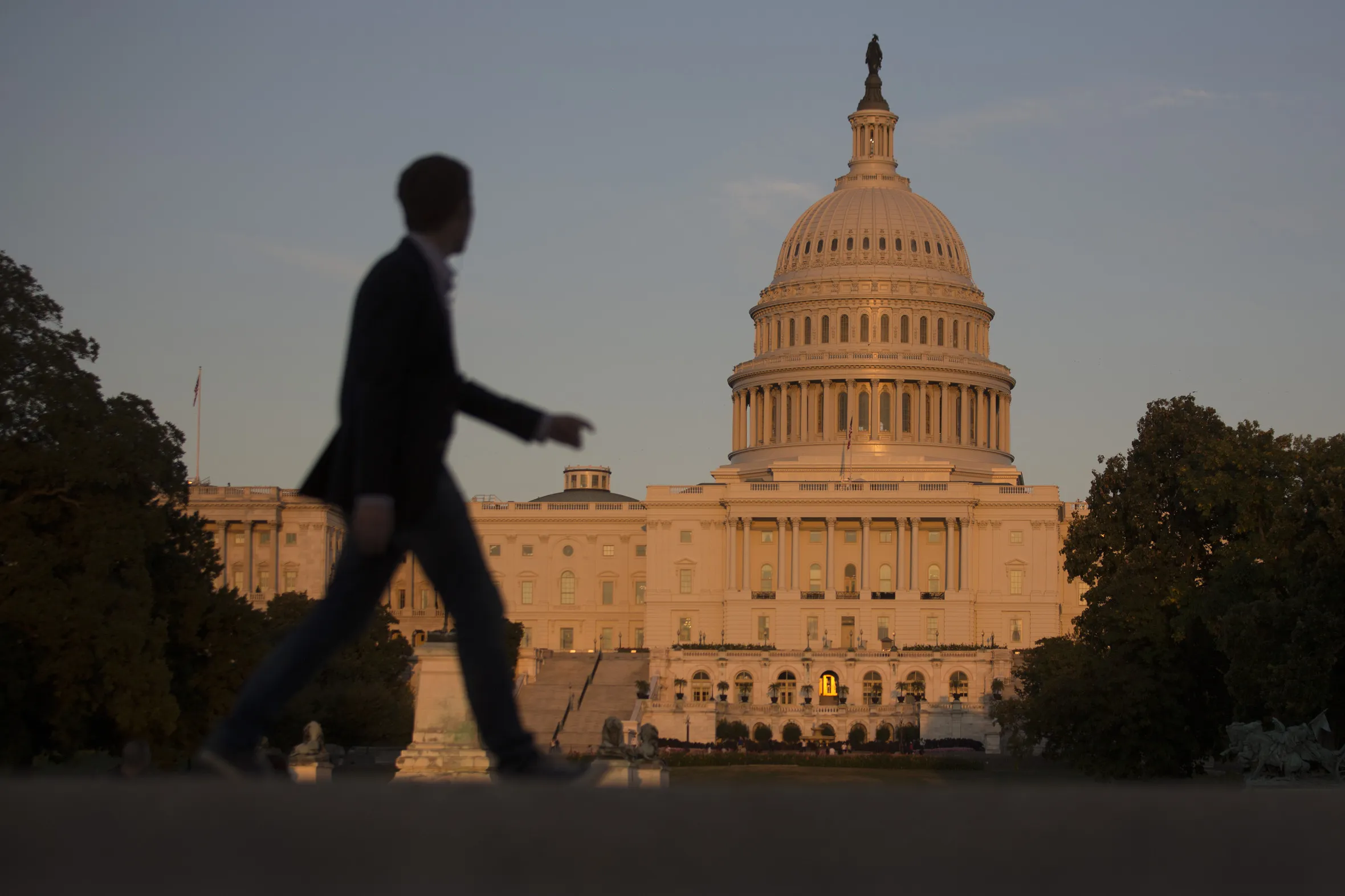 A pedestrian walks past the US Capitol in Washington.