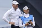 England's golfer Alex Wrigley gets supported by his wife Johanna Gustavsson during a practice round at the British Open golf championship in St Andrews, Scotland, Tuesday, July 12, 2022. The Open Championship returns to the home of golf on July 14-17, 2022, to celebrate the 150th edition of the sport's oldest championship, which dates to 1860 and was first played at St. Andrews in 1873. (AP Photo/Alastair Grant)