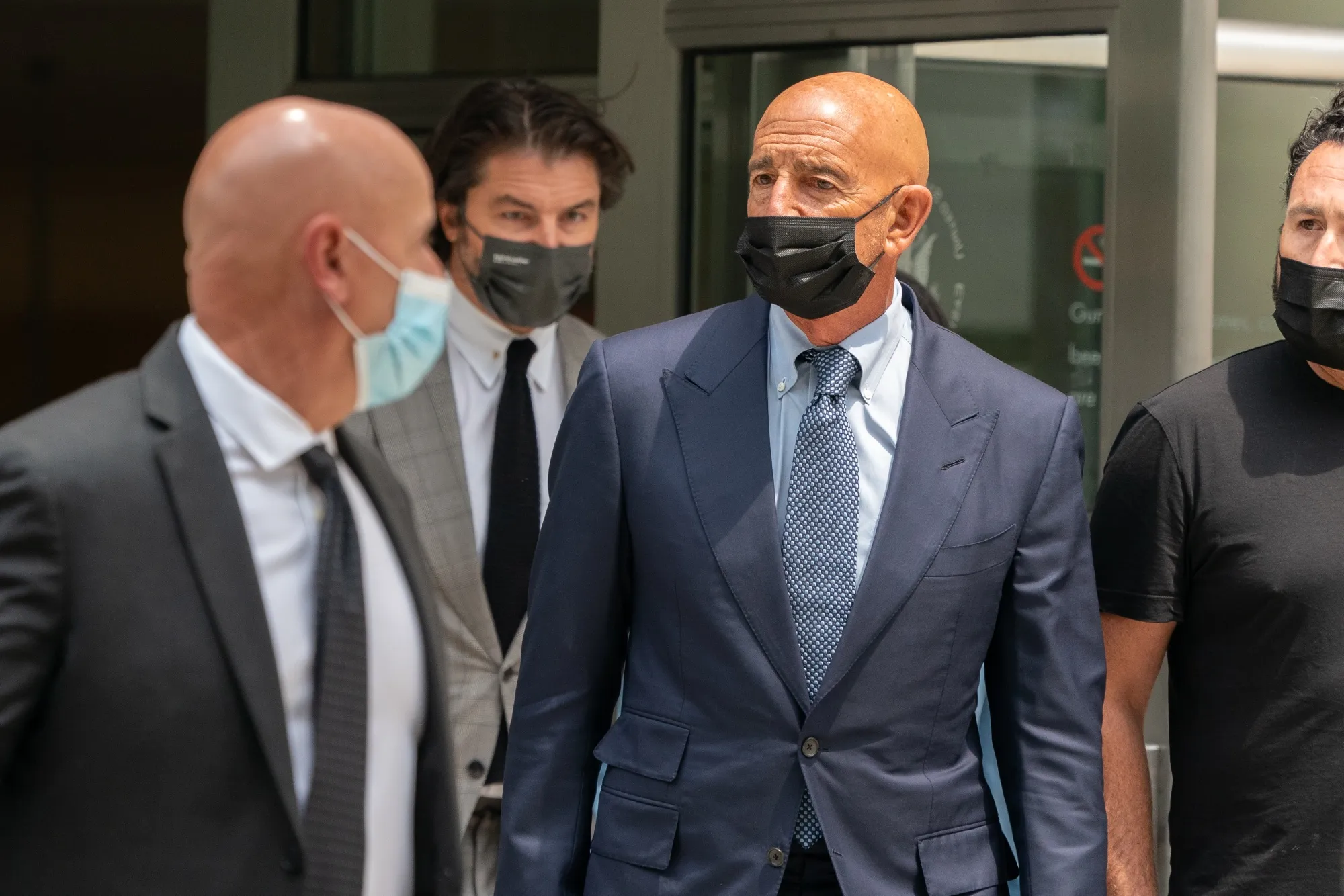 Tom Barrack Jr., center, departs from criminal court in New York, U.S., on July 26.