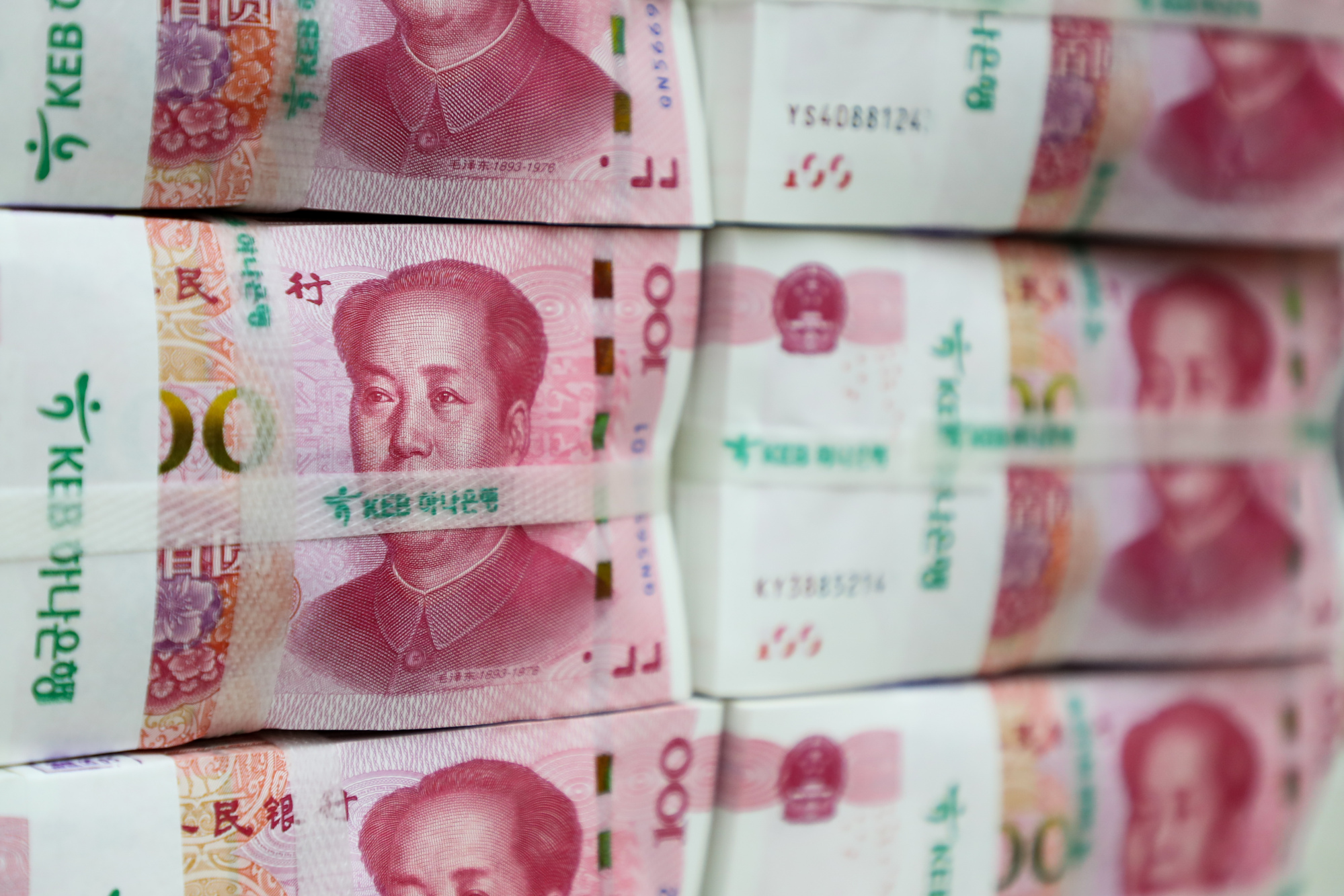 China's Yuan Sinks With Bonds as Stocks Rally on Easing Signs