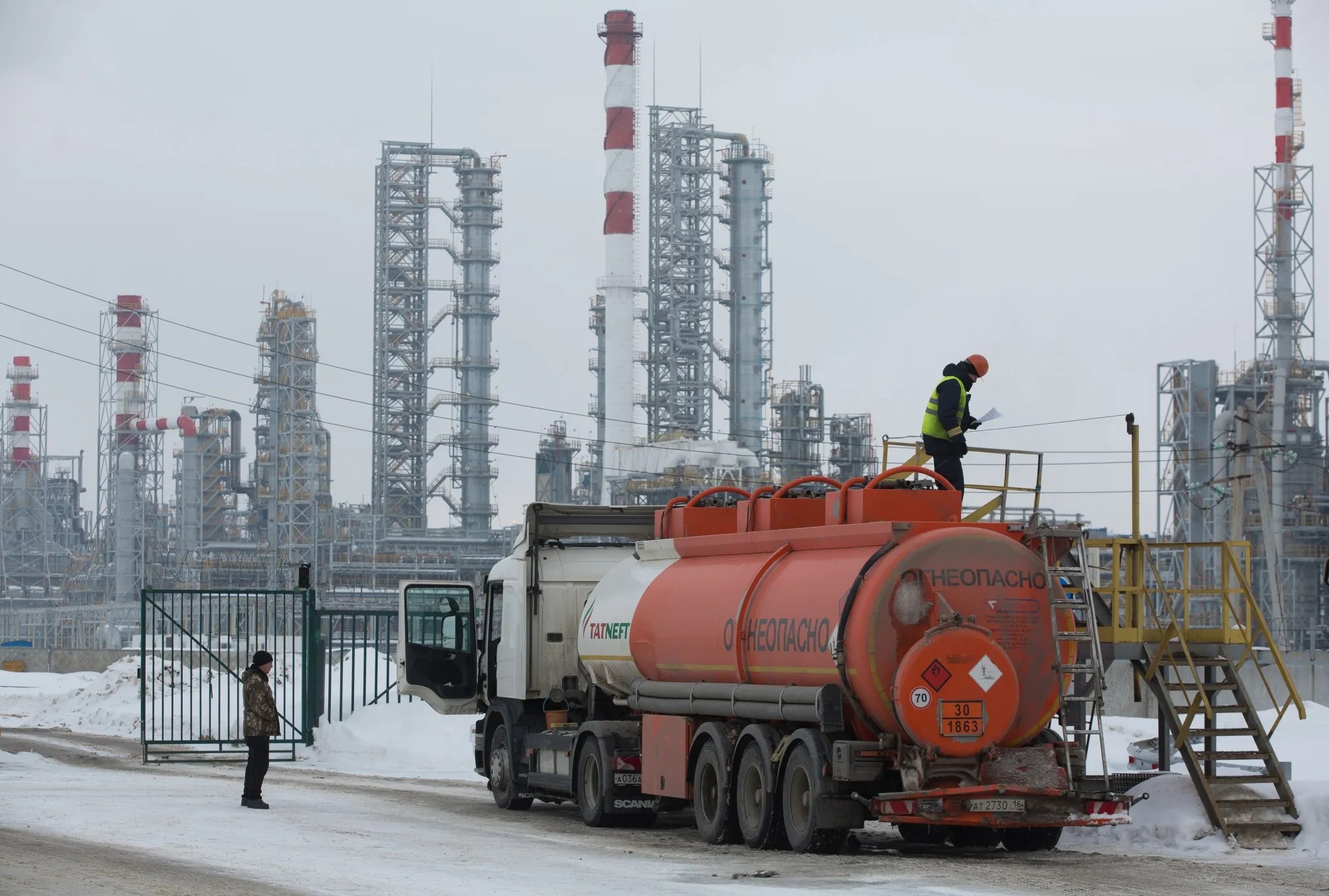 Workers load a tanker truck with petroleum fuel at the Taneco Oil Refining and Petrochemical complex in Nizhnekamsk, Tatarstan, Russia.