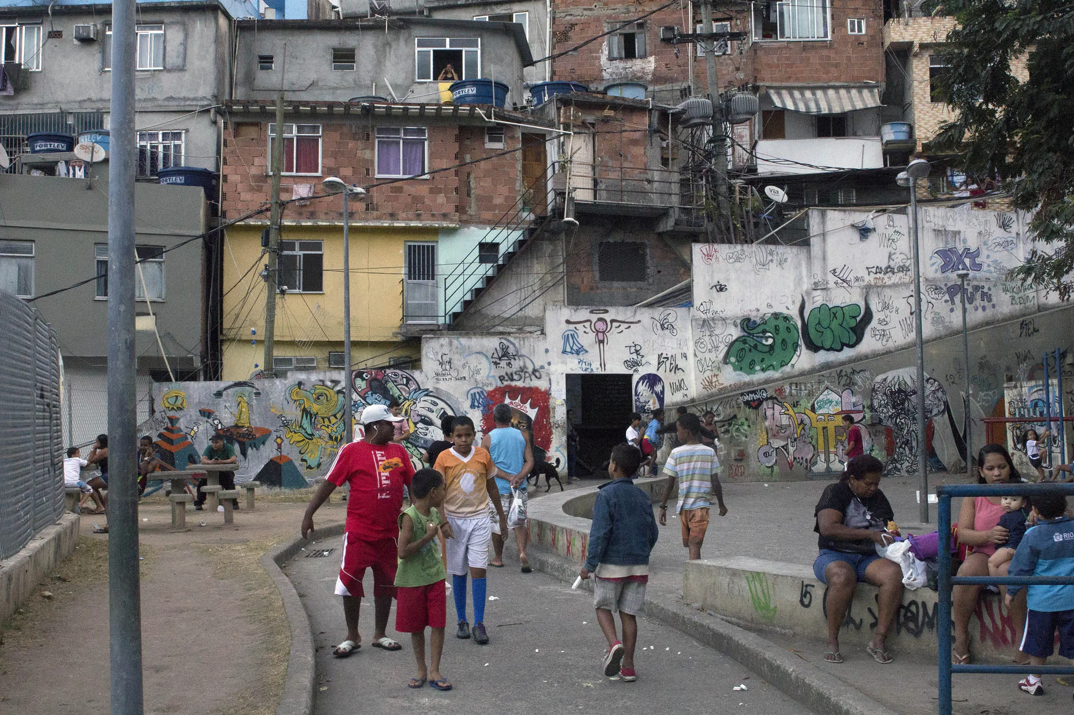 Houses stand behind a playground at the Rocinha favela in Rio de Janeiro, Brazil. Brazil’s economy grew less than the euro area in 2014, the first time since 2001. The International Monetary Fund forecast a contraction of 3.5 percent this year and stagnation next, after a 3.8 percent recession in 2015.
