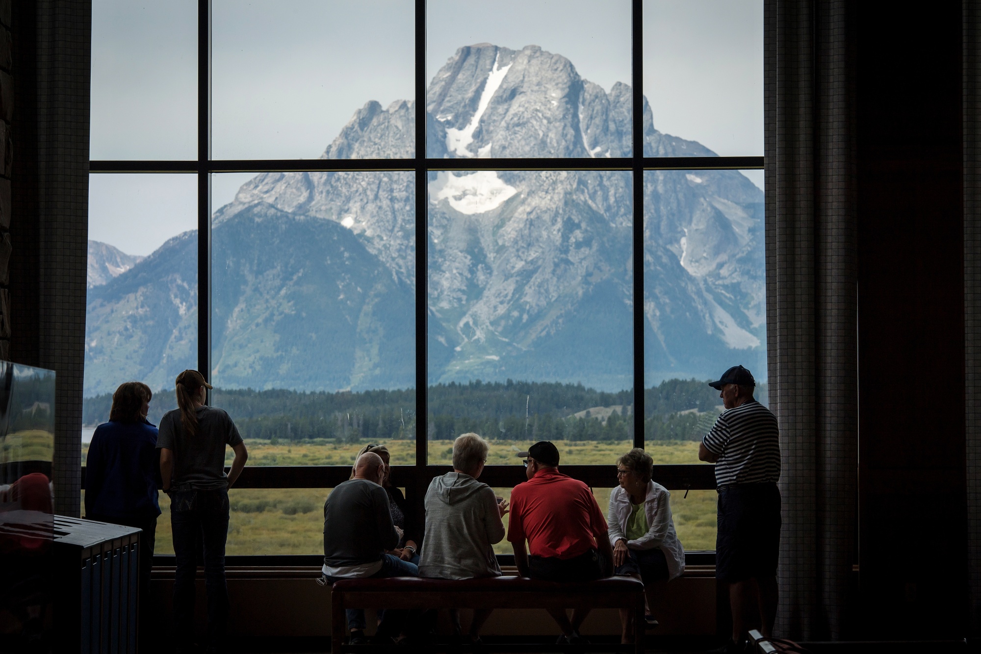 Visitors view the Grand Teton National Park mountain range from the Jackson Lake Lodge in Moran, Wyoming.