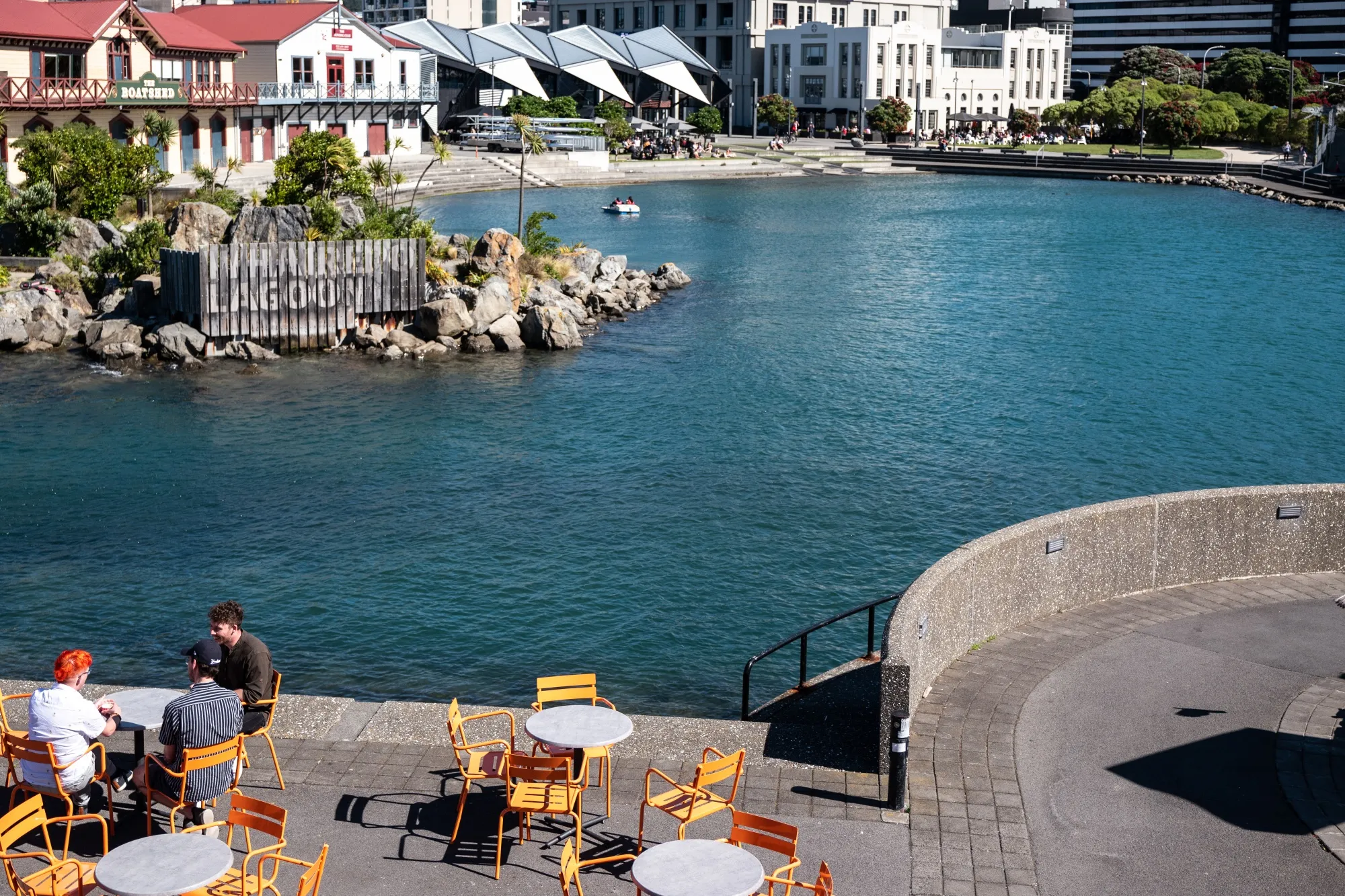 People sit outside at a bar at Taranaki Street Wharf in Wellington, New Zealand, on Dec. 15.