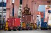 A gantry crane unloads a shipping container at the Port of Busan in Busan.