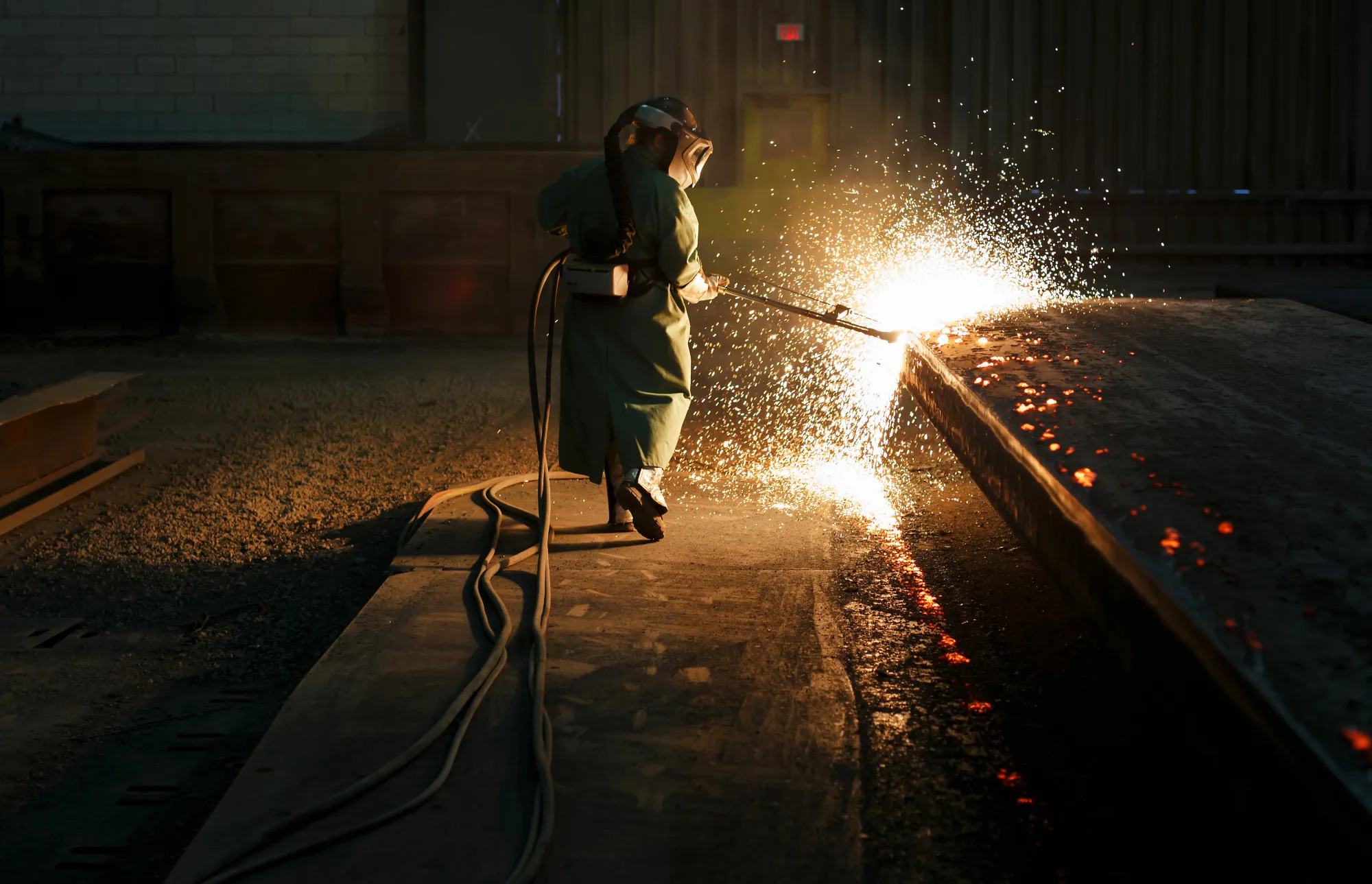 Sparks fly as an employee performs a quality check on a steel slab at a&nbsp;plant in Nanticoke, Ontario, Canada.