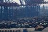 Containers stand beneath shipping cranes at the Port of Hamburg in Hamburg, Germany, on Thursday, May 31, 2018. America's closest allies plan to slap billions of dollars in tit-for-tat tariffs on U.S. goods after the Trump administration announced it’s imposing steel and aluminum duties on them.