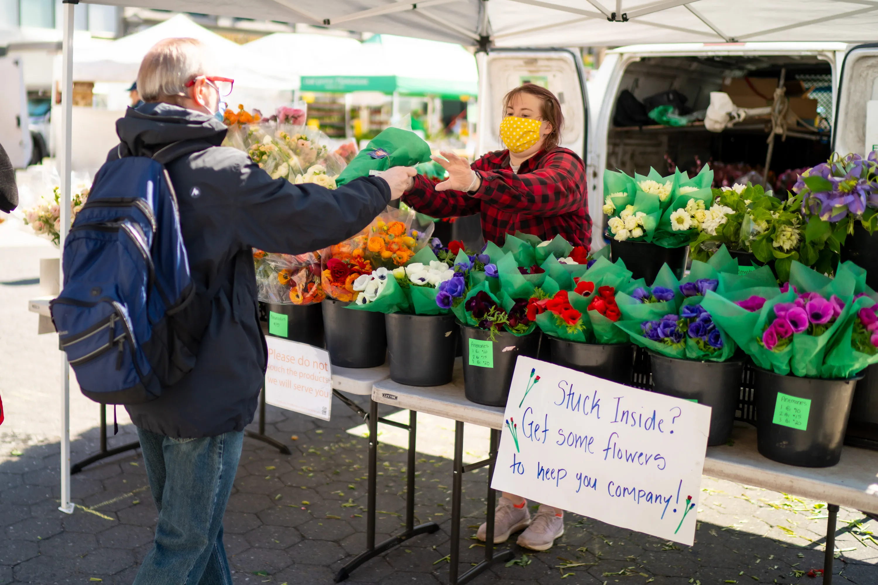 A customer buys flowers at the Union Square farmers market in New York City on April 15.