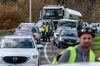 Demonstrators wearing yellow vests (Gilets jaunes) talk to drivers as they sit stationary during a protest against fuel costs near Rodez, France, on Nov. 17, 2018.