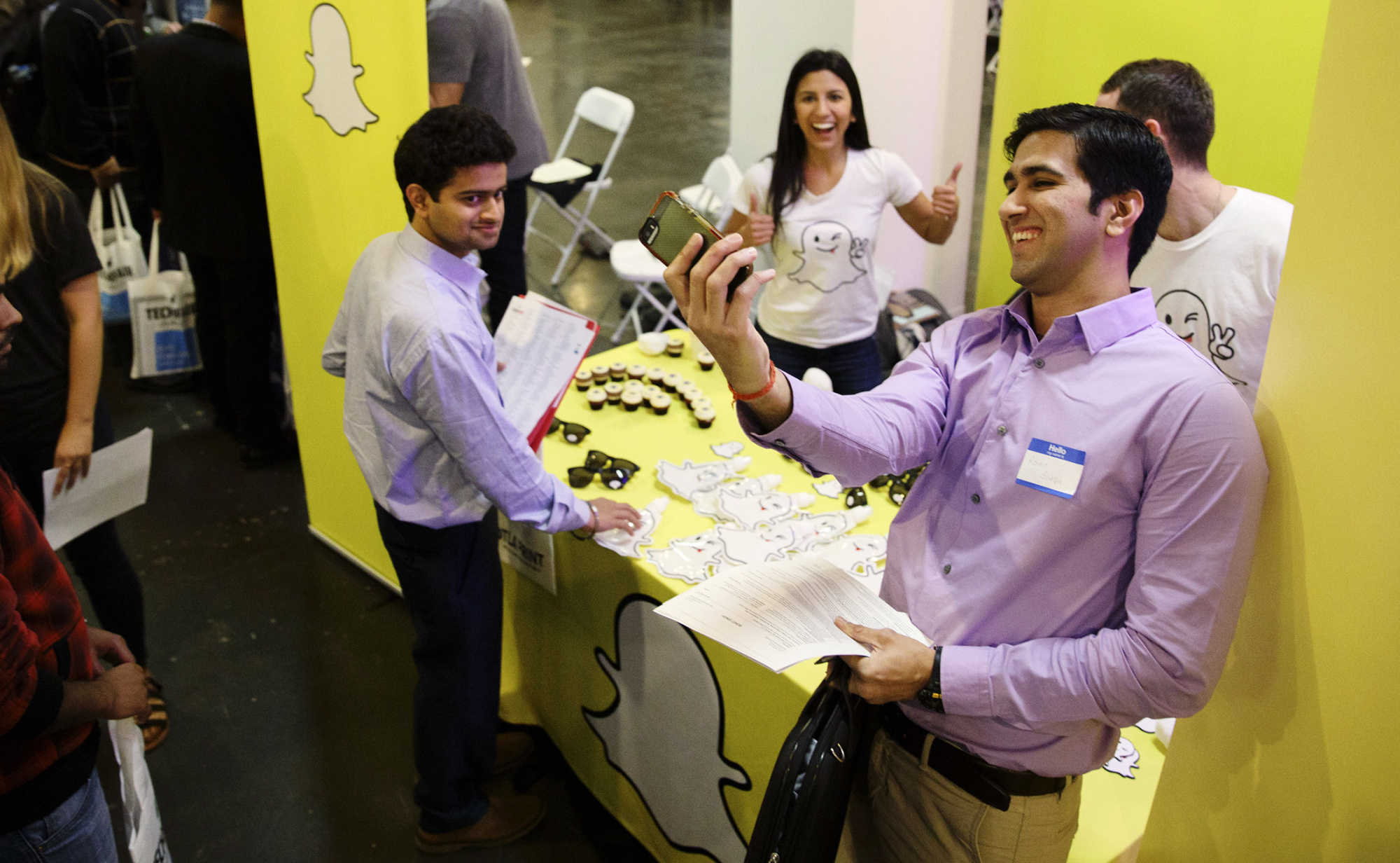 A job seeker takes a Snapchat photo with Snap Inc. representatives during the TechFair LA job fair in Los Angeles on Jan. 26.
