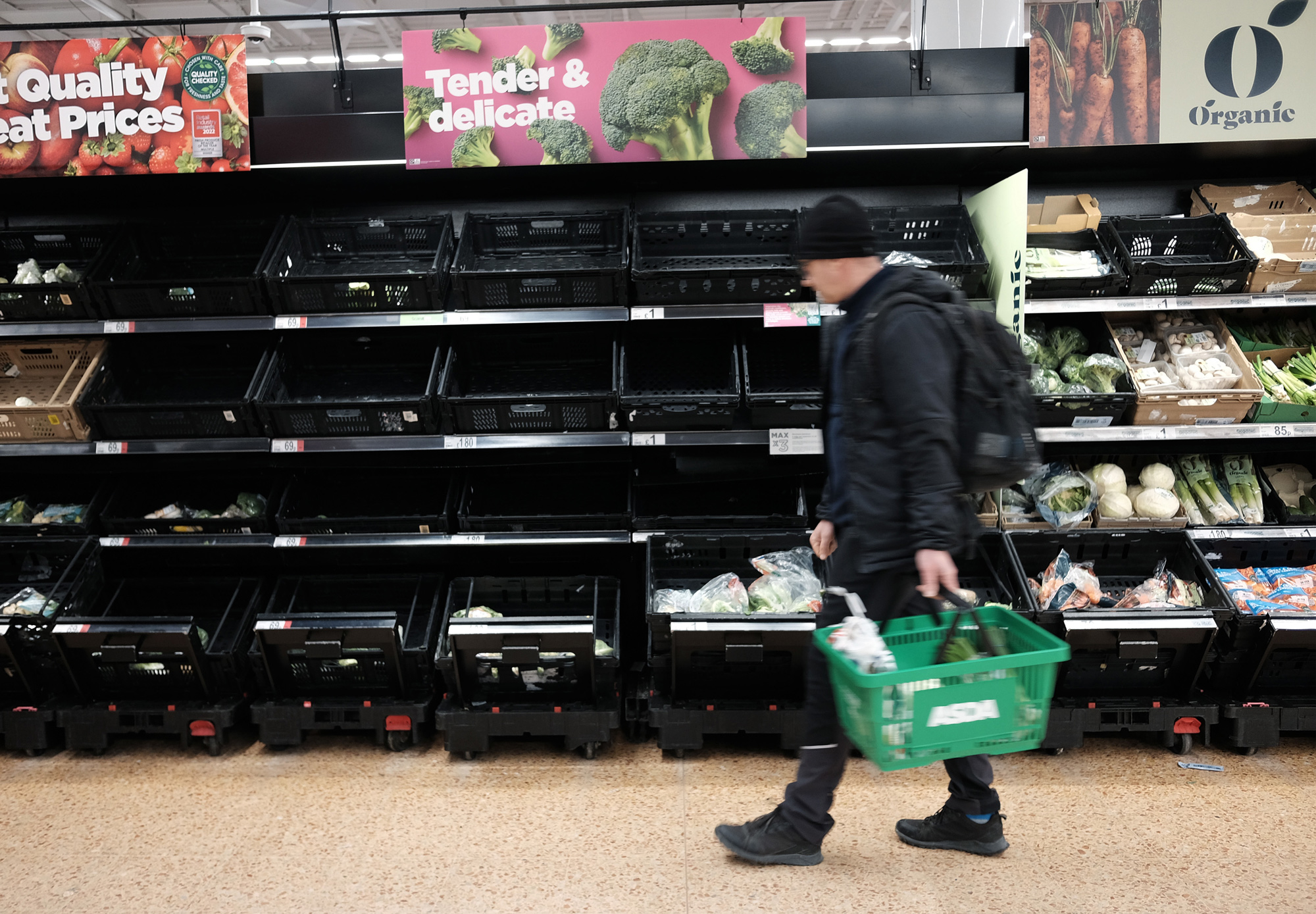 Empty fruit and vegetable shelves at an Asda store in London.