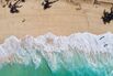 Aerial view of bright blue water and surf with waves crashing at Bonzai Pipeline and Sunset Beach Park on North Shore, Haleiwa, Oahu, Hawaii, USA.