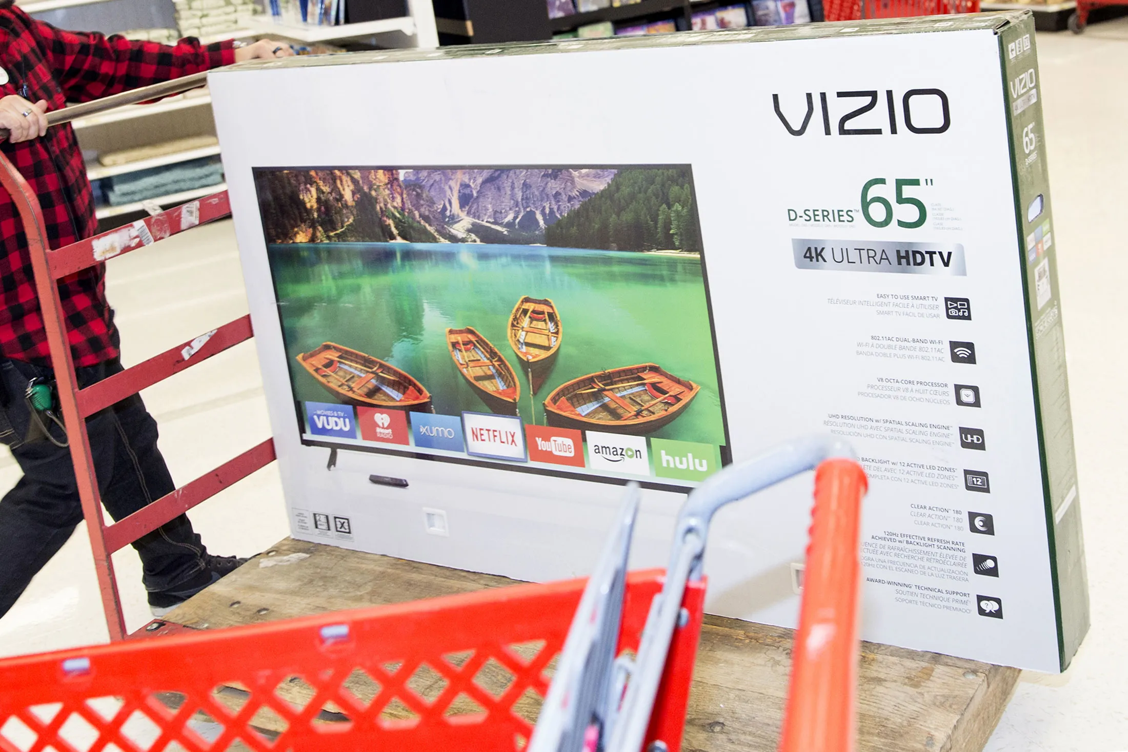 An employee pushes a trolley with a Vizio Inc. high-definition television (HDTV) at a Target Corp. store on Black Friday in Dallas, Texas, on Friday, Nov. 24, 2017.