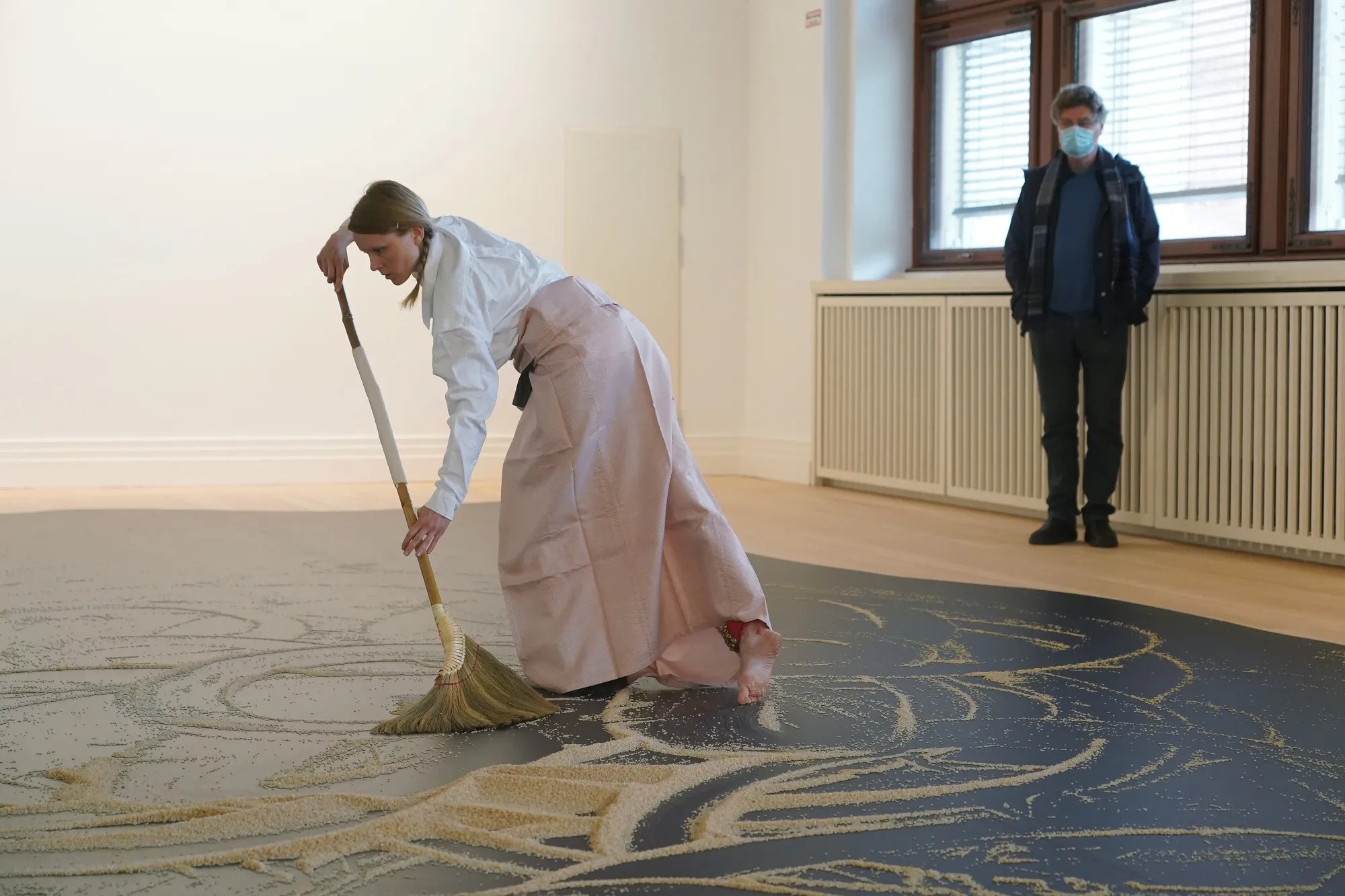A visitor wearing a protective face mask watches a dancer perform the installation piece "Our Labyrinth" at the Lee Mingwei exhibition in Berlin on May 11.