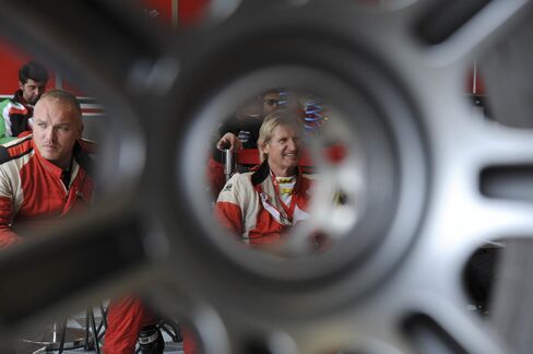 Mechanics of the Ferrari 458 Italia sit during the 83rd Le Mans 24-hour endurance race, on June 14, 2015, in Le Mans.