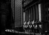 (EDITORS NOTE: Image has been converted to black and white.) American flags fly outside of the New York Stock Exchange (NYSE) in New York, U.S., on Thursday, Feb. 25, 2016. Stocks retreated with government bonds, while the euro rallied to the highest level in almost a month as investors looked past an unprecedented boost from European monetary policy to focus on rising anxiety that policymakers have lost the ability to jumpstart global growth and stave off deflation.