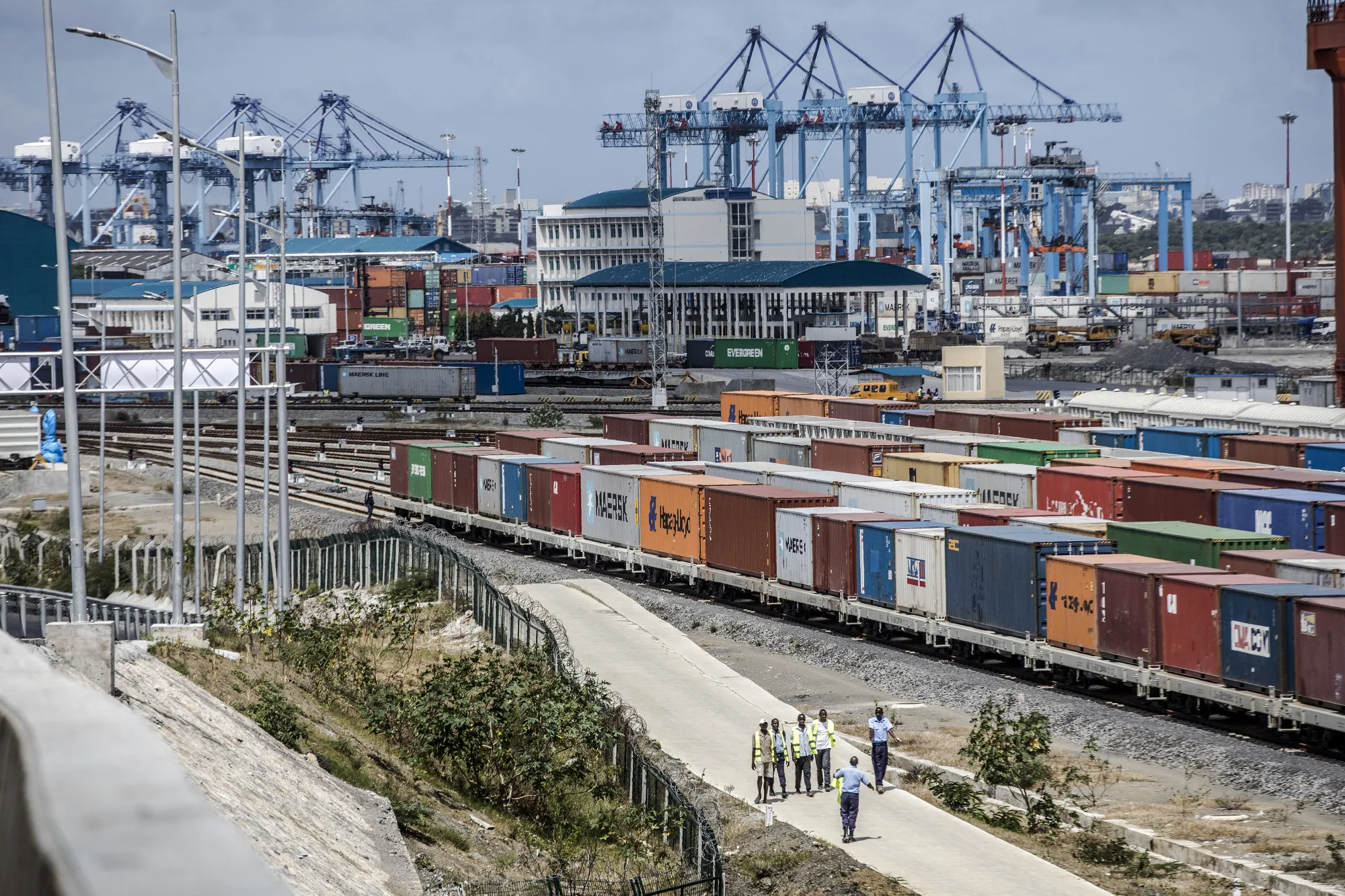 Shipping containers sit beside railway lines running into Mombasa port, operated by Kenya Ports Authority, in Mombasa.