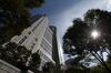 A worm's eye view of a tall granite building on a sunny day