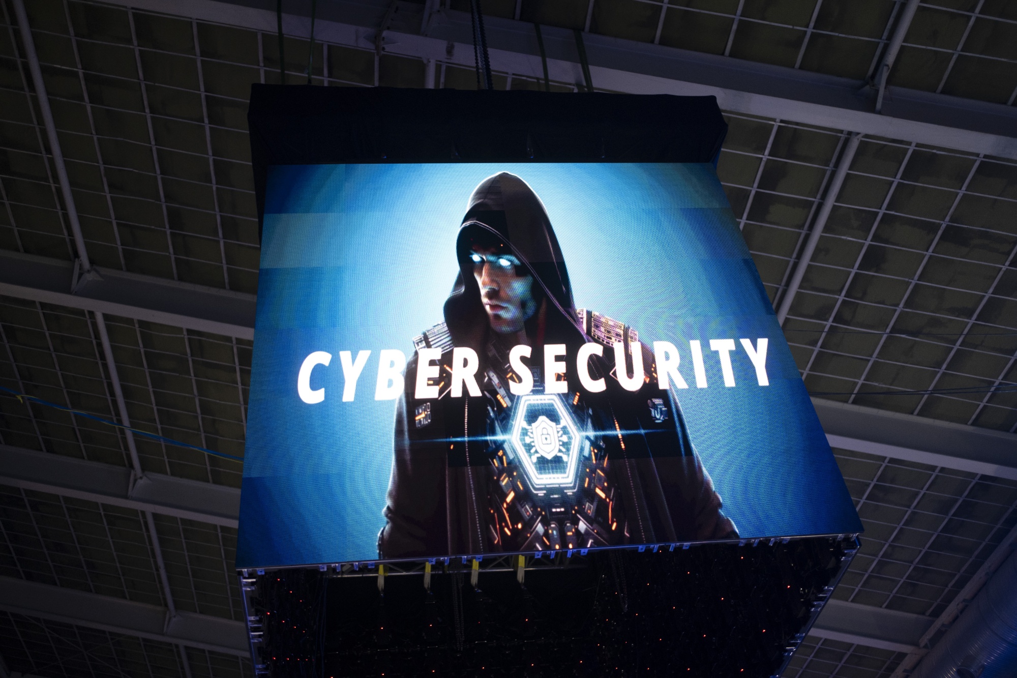 A giant display features a symbolic image of a hacker during the cybersecurity section of Iran's 2025 Tech Olympics, held at Pardis Technology Park in northeastern Tehran, Iran, on October 28, 2025. At Iran's 2025 Technology Olympics, held at Pardis Technology Park, hackers from eight countries, including Pakistan, Tunisia, China, and Russia, participate in the cybersecurity section. (Photo by Morteza Nikoubazl/NurPhoto via Getty Images)