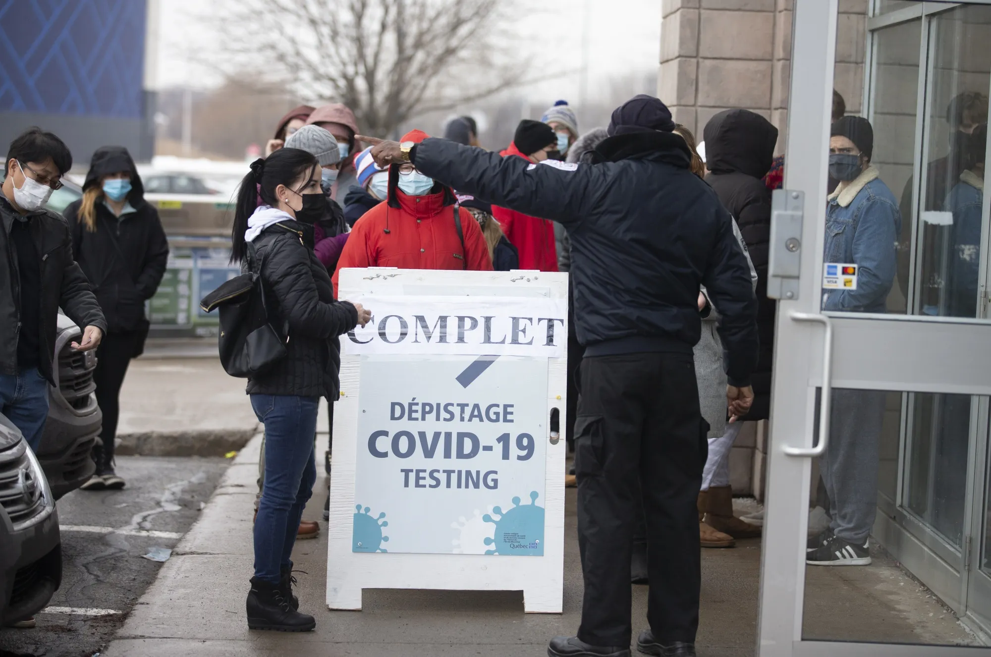 Residents wait in line outside a Covid-19 testing center in the Montreal suburbs on Dec. 22, 2021.