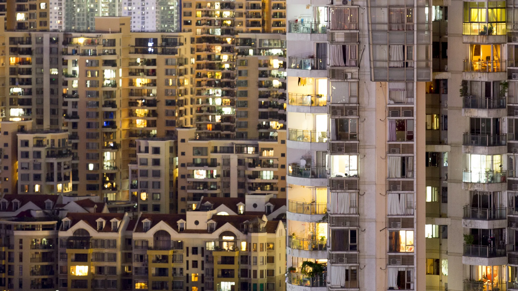 Residential buildings stand illuminated in Shenzhen, China.

