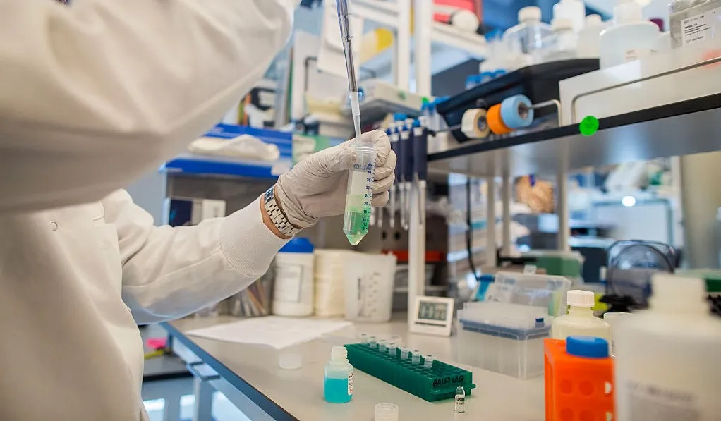 A worker tests a liquid chemical inside of a laboratory at the Pfizer Inc. research and development facility in Cambridge, Massachusetts, U.S., on Monday, Oct. 26, 2015. Pfizer is expected to report quarterly earnings on October 27.