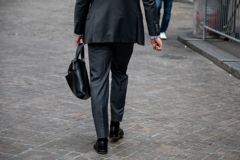 A pedestrian walks along Wall Street  in New York, June 9, 2023. 