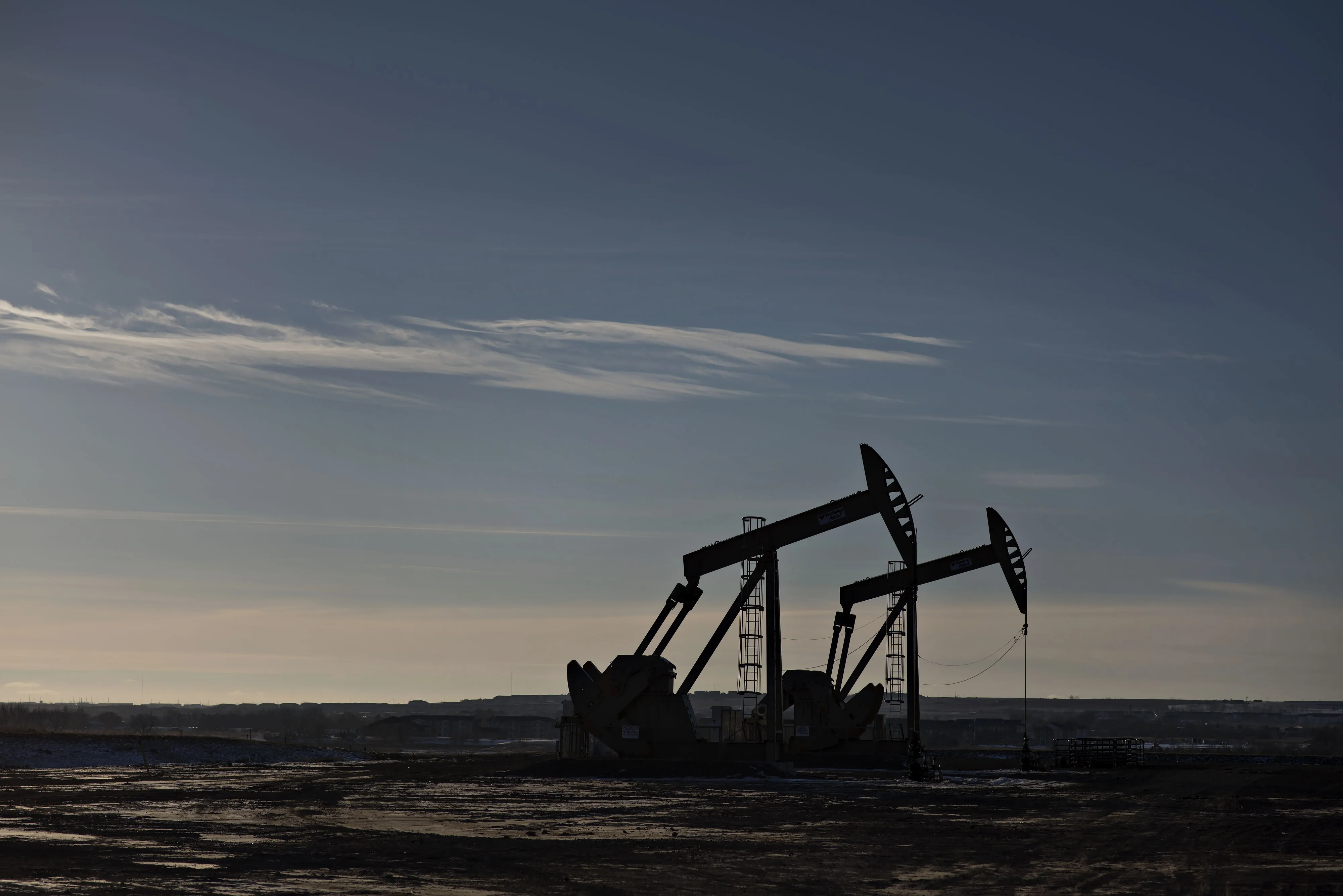 Pumpjacks stand on the site of an oil well outside Williston, North Dakota, U.S., on Wednesday, Feb. 11, 2015.
