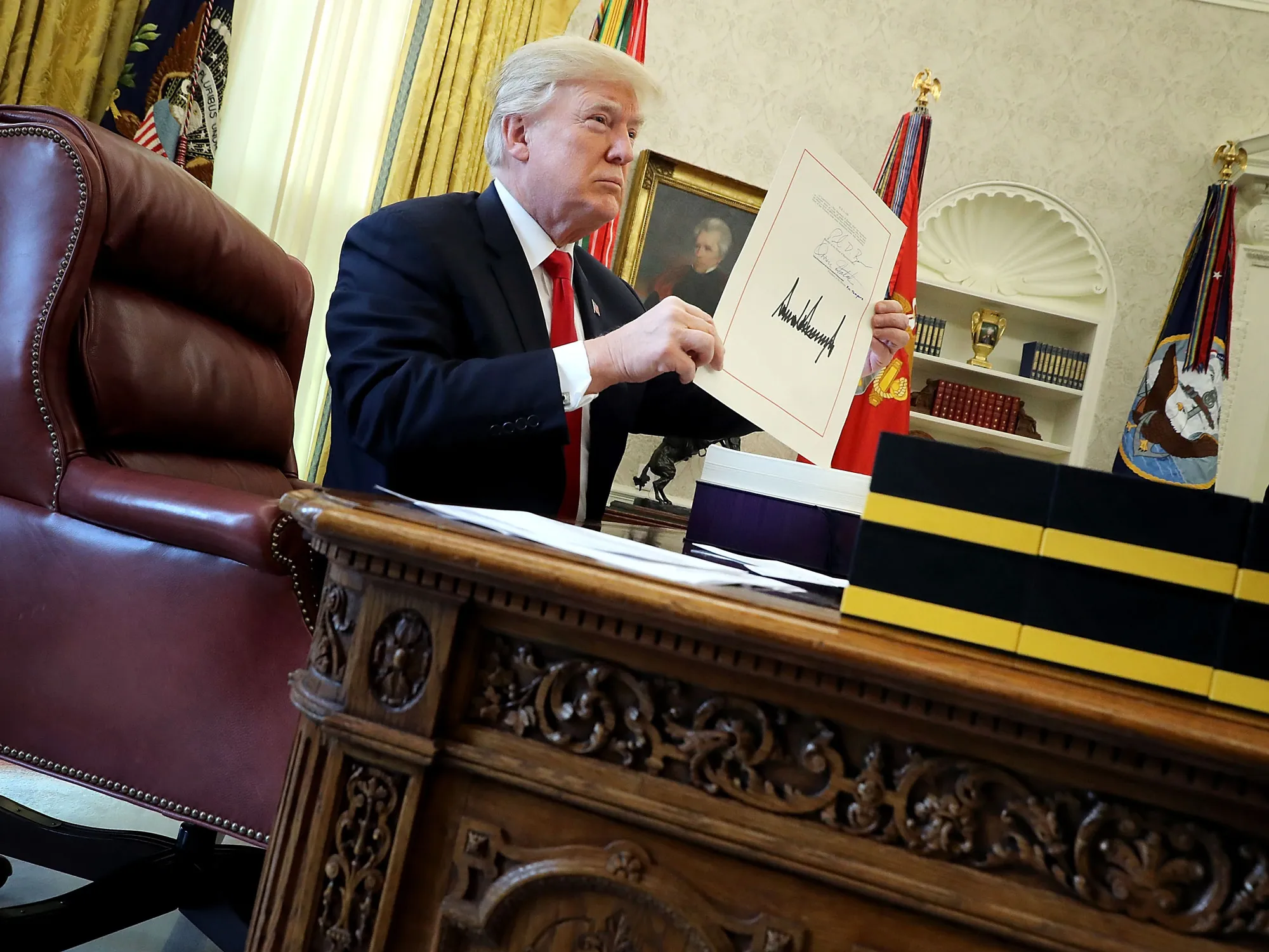 Donald Trump signs the Tax Reform bill into law at the Oval Office in Dec. 2017.