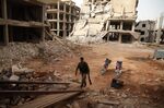 A Syrian rebel-fighter enters a building in the rebel-held al-Rashidin district of western Aleppo's countryside near Idlib province.