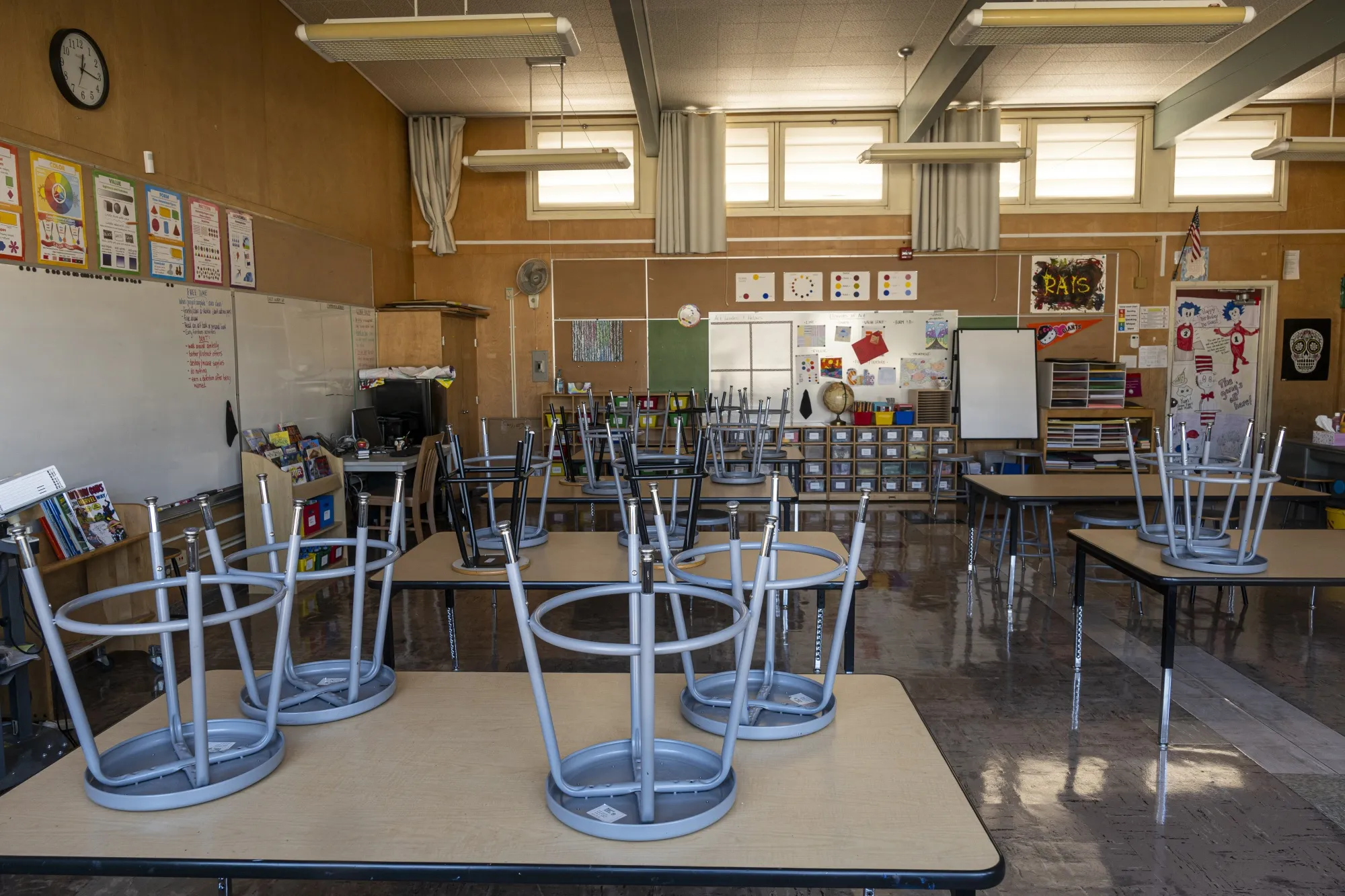 Stools on desks inside an empty classroom at a school in California.