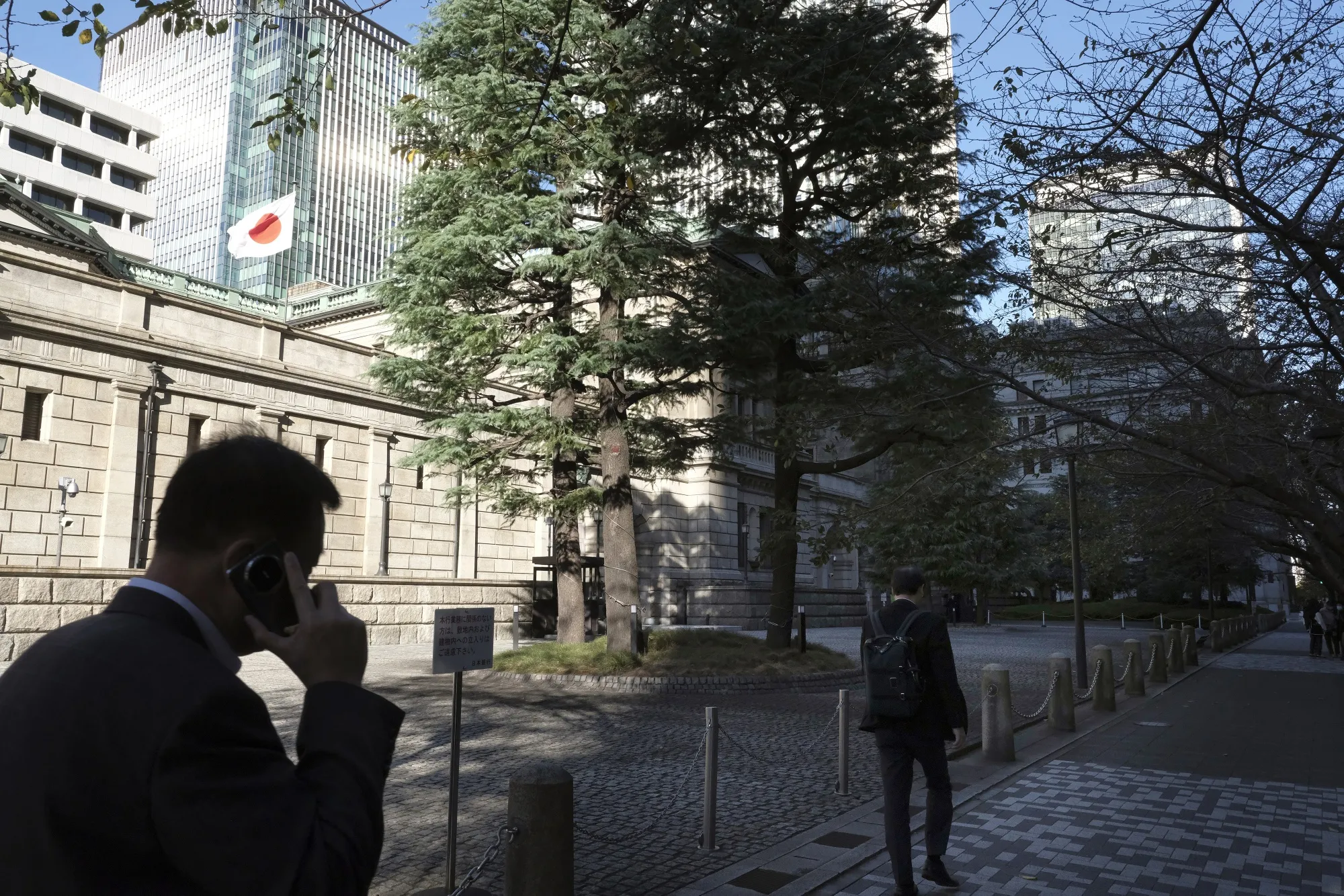 Pedestrians in front of the Bank of Japan&nbsp;headquarters in Tokyo.