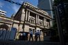 People enter the Bank of Japan (BOJ) headquarters in Tokyo, Japan.