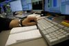 A trader monitors financial data inside the Frankfurt Stock Exchange, operated by Deutsche Boerse AG, in Frankfurt, Germany, on Friday, March 23, 2018. Stock declines deepened globally on Friday, with European equities sliding to the lowest in more than a year and gauges tumbling across Asia as the negative news cycle for risk assets continued.